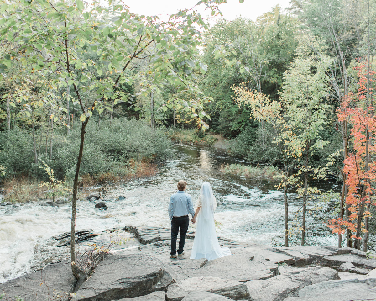 A couple looking out over Stubbs falls in Arrowhead Provincial Park for their intimate elopement in Ontario