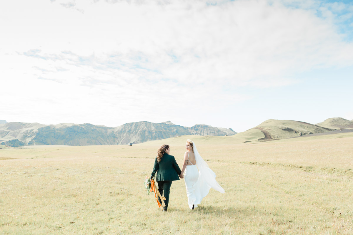 Joanna and Kili walking towards a cool mountain range after their wedding vows on their elopement day in Iceland