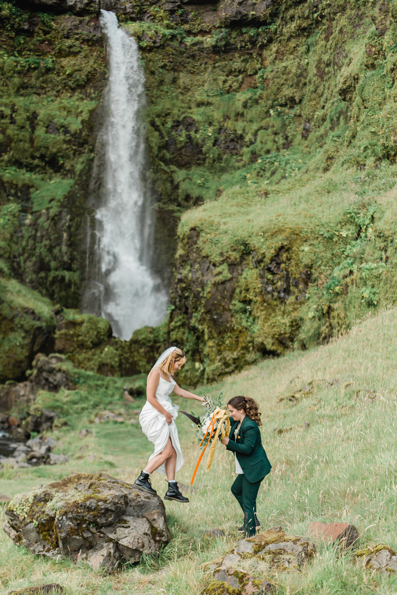 Joana and Kili celebrating their wedding in Iceland in front of an epic private waterfall during their elopement 