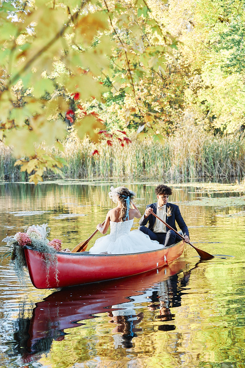 A couple enjoying their romantic activity of canoeing together. They had a beautiful intimate elopement at a private camping airbnb close to Prince Edward County in Ontario