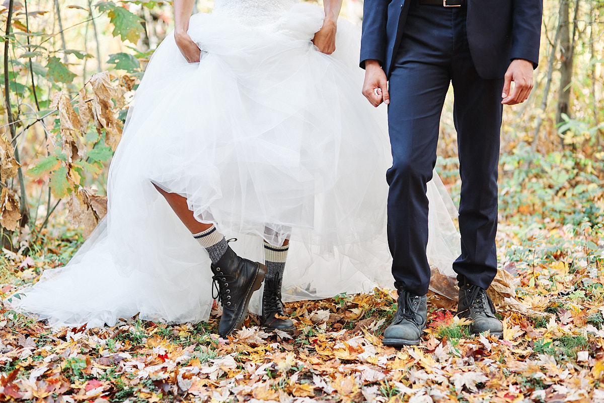 A cute photo of a couple's footwear of doc martens and hiking boots during their elopement at a Muskoka cabin in the middle of Autumn in Ontario Canada