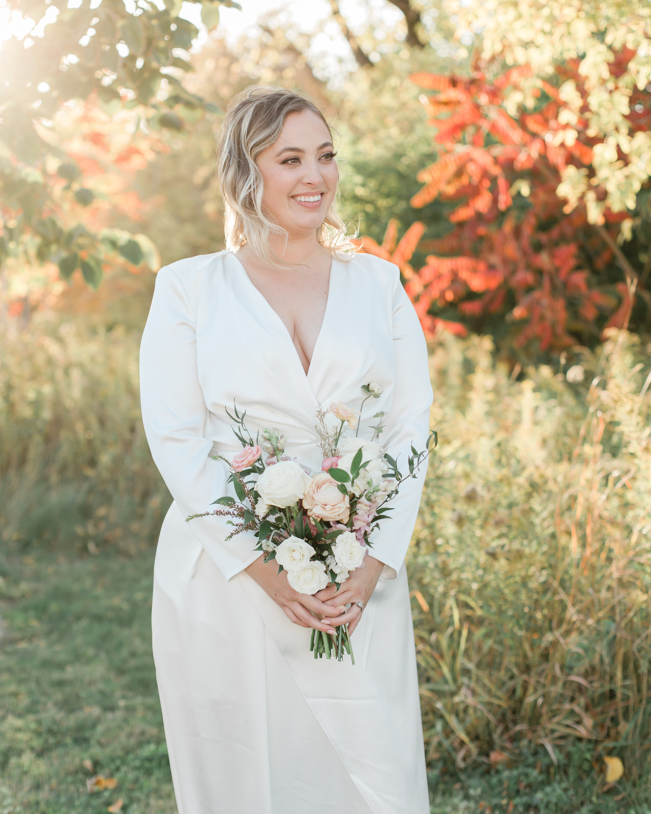 A portrait of a bride holding her bouquet during autumn for her elopement in Ontario