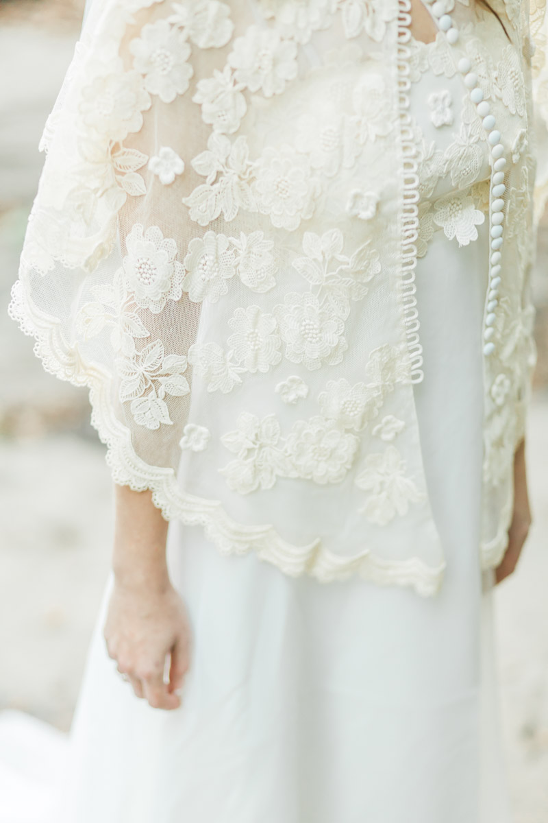 A detail photo of a bride's gown that her mother passed down to her during the elopement at Stubbs Falls near Huntsville in Arrowhead Provincial Park in Ontario Canada