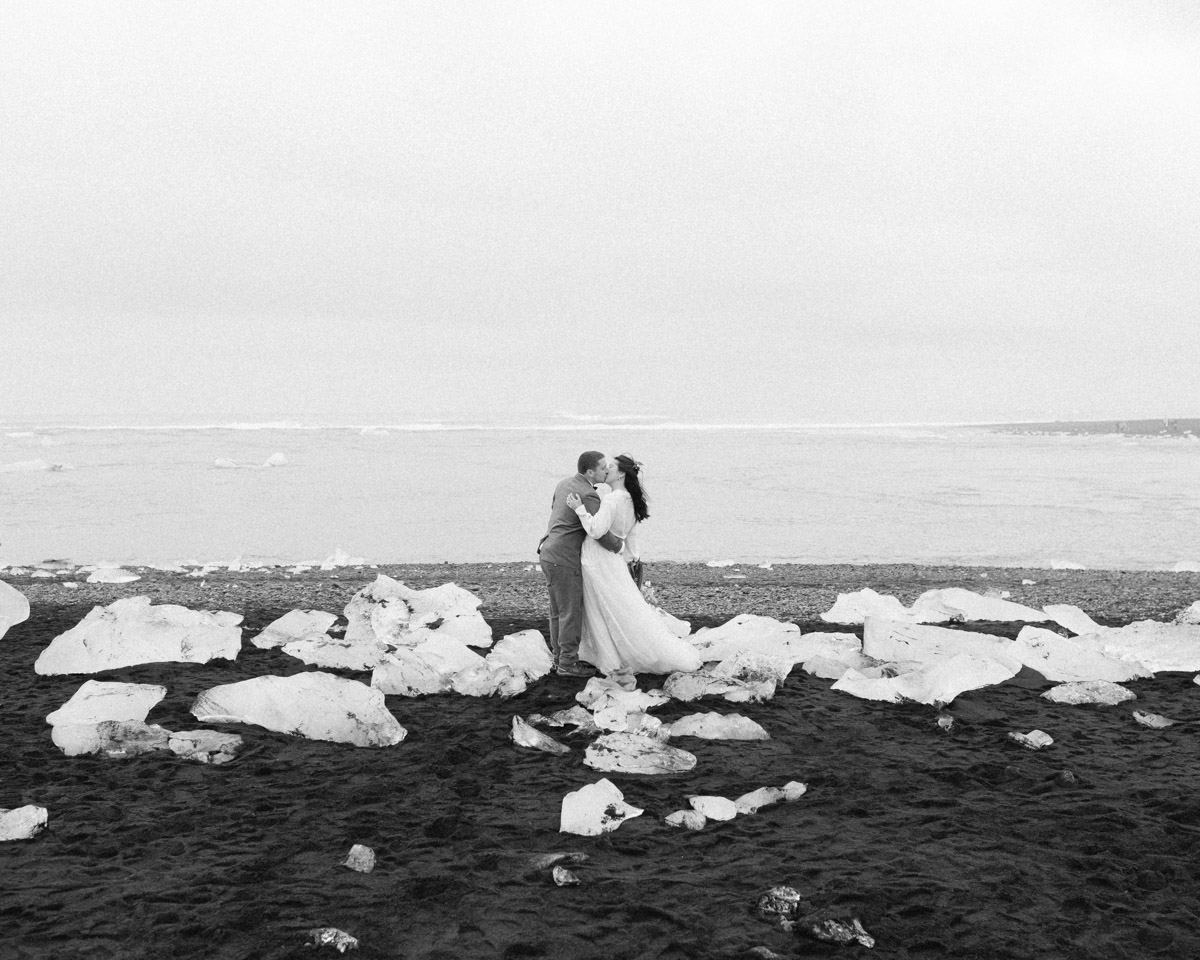 Leah and Darin kissing after their elopement at Diamond beach in Iceland