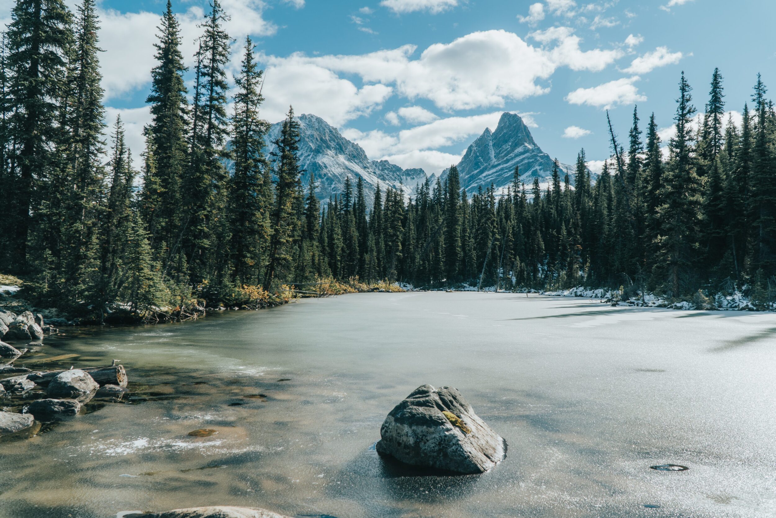 An small lake is pictured beneath some Canadian Rockies mountain peaks in Jasper National Park. 