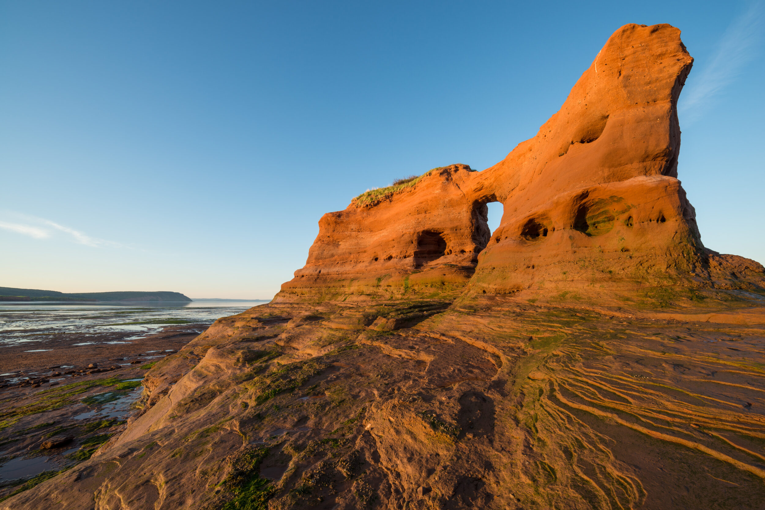 A view at sunset of a rock formation at low tide on the Bay of Fundy, Nova Scotia.