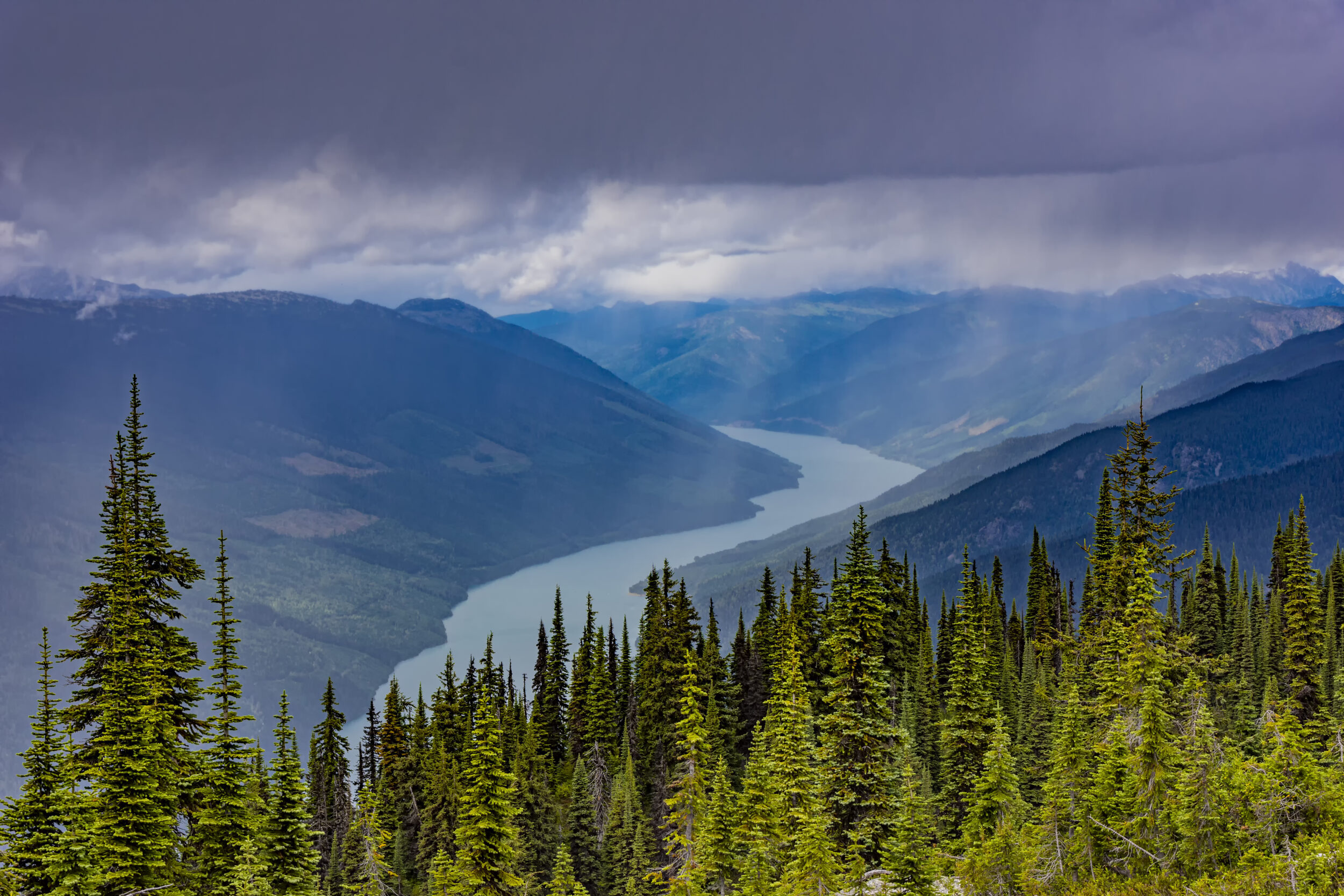 An elevated view of Lake Revelstoke from Mount Revelstoke British Columbia Canada on a stormy day