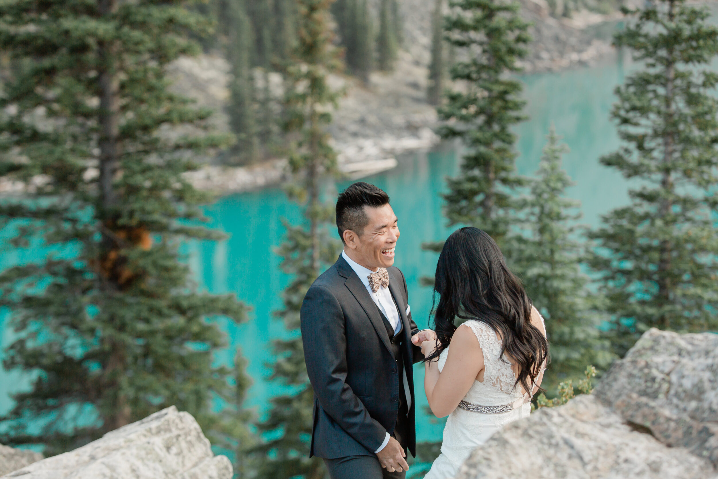 A couple exchanges vows overlooking an alpine lake in Alberta.