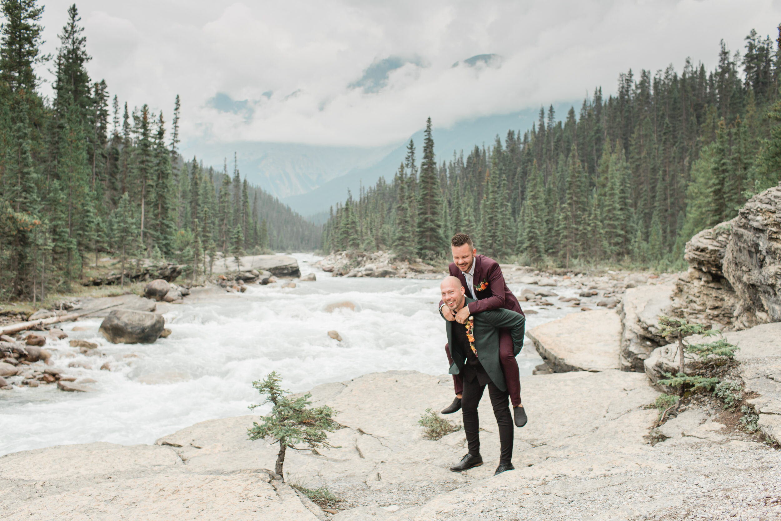 A couple shares a laugh after eloping in Banff National Park.