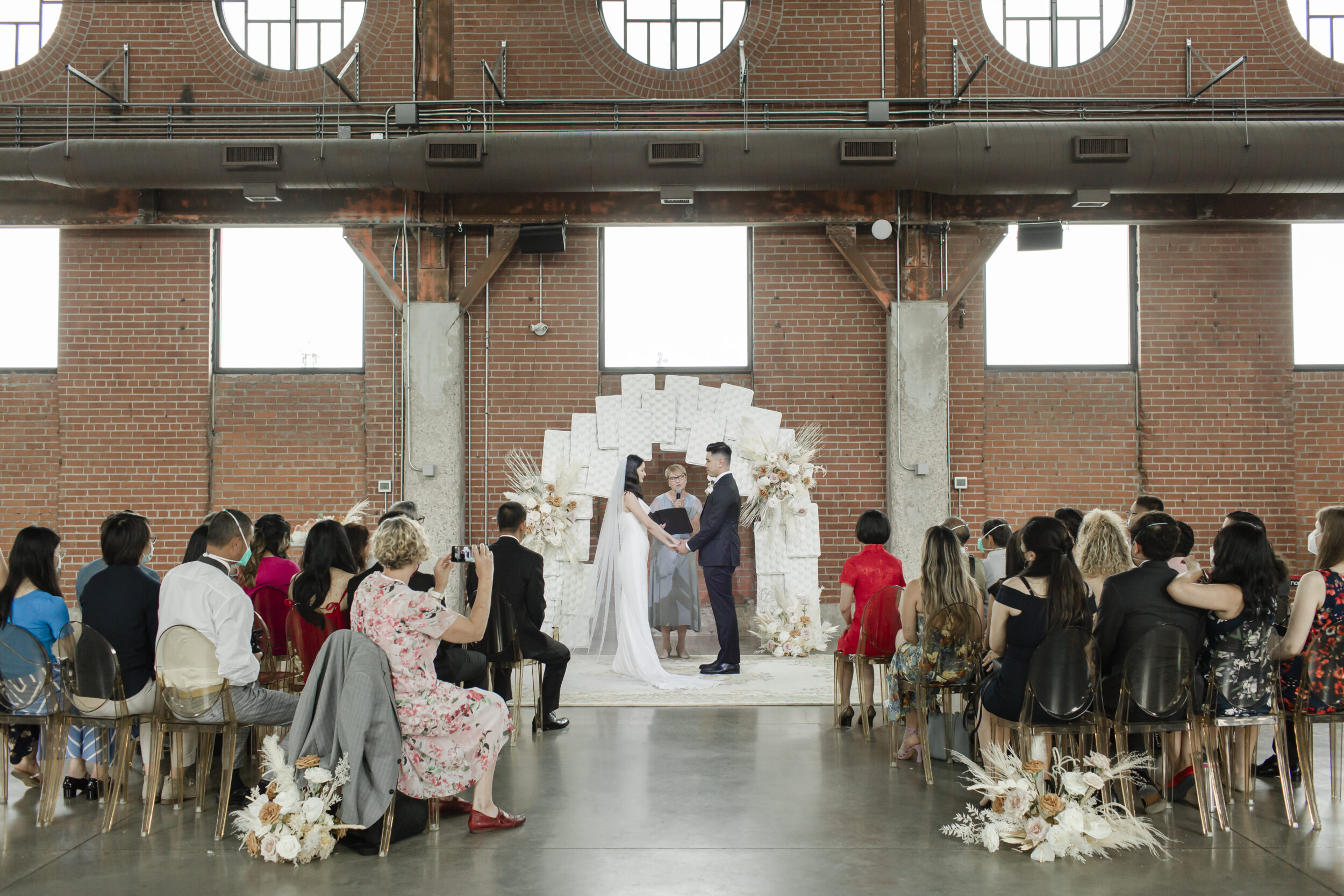 A wedding ceremony is seen in Toronto at Evergreen Brickworks.