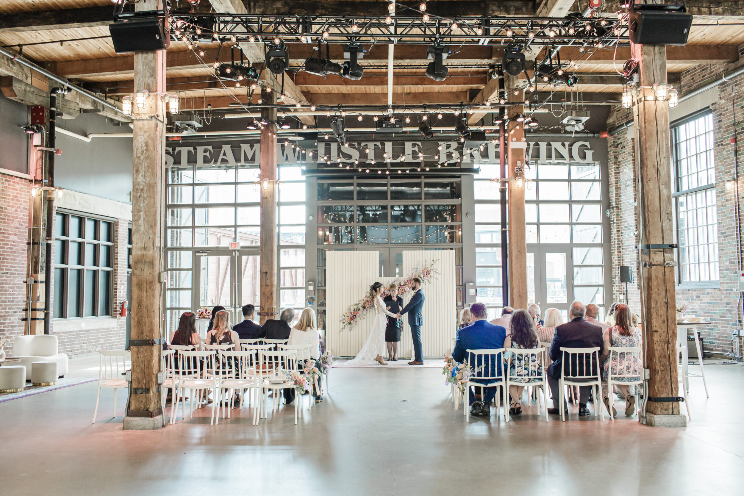 A couple says their wedding vows at a distillery in Toronto. 