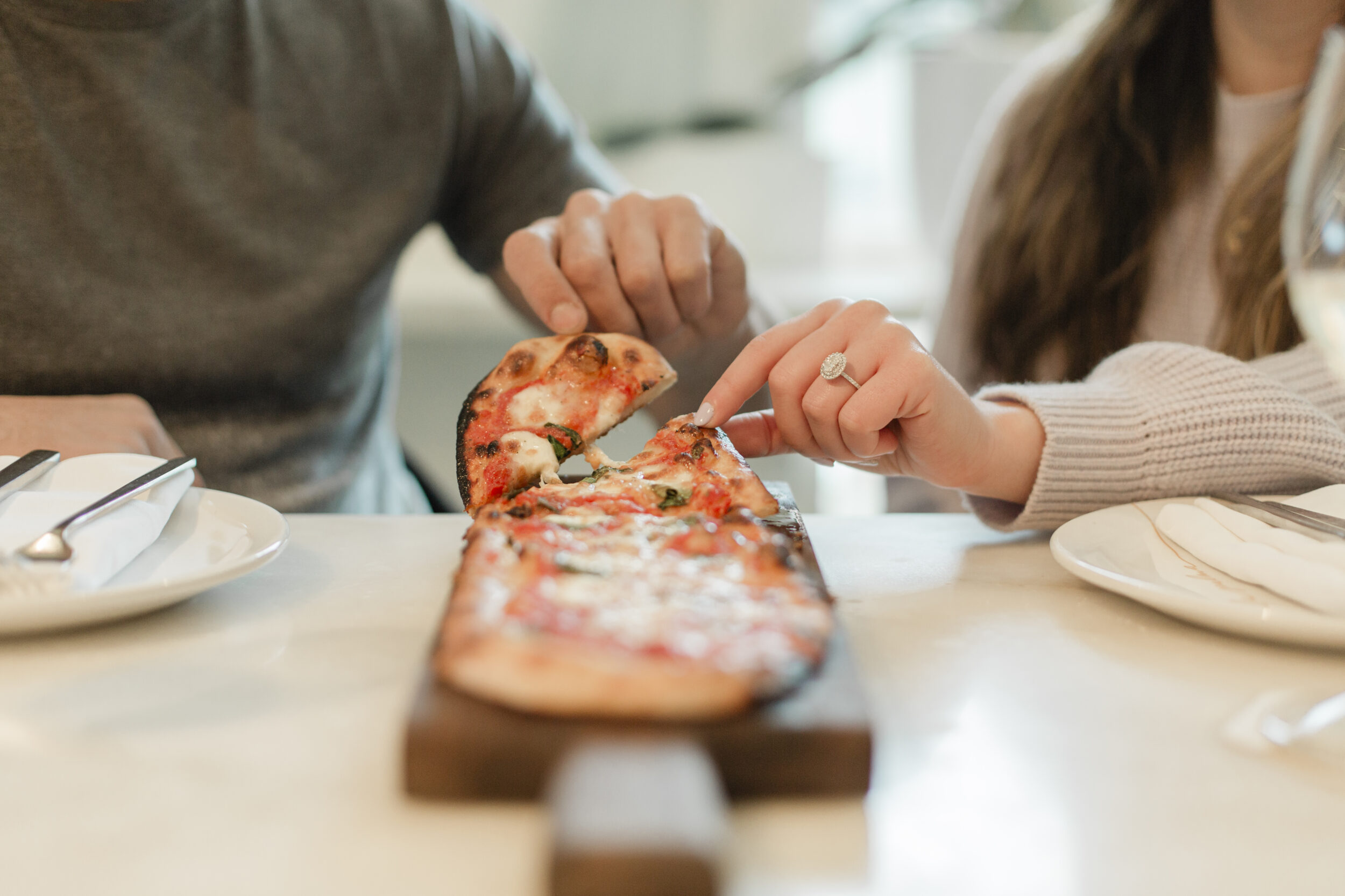 A couple is shown sharing a flatbread pizza in Toronto.