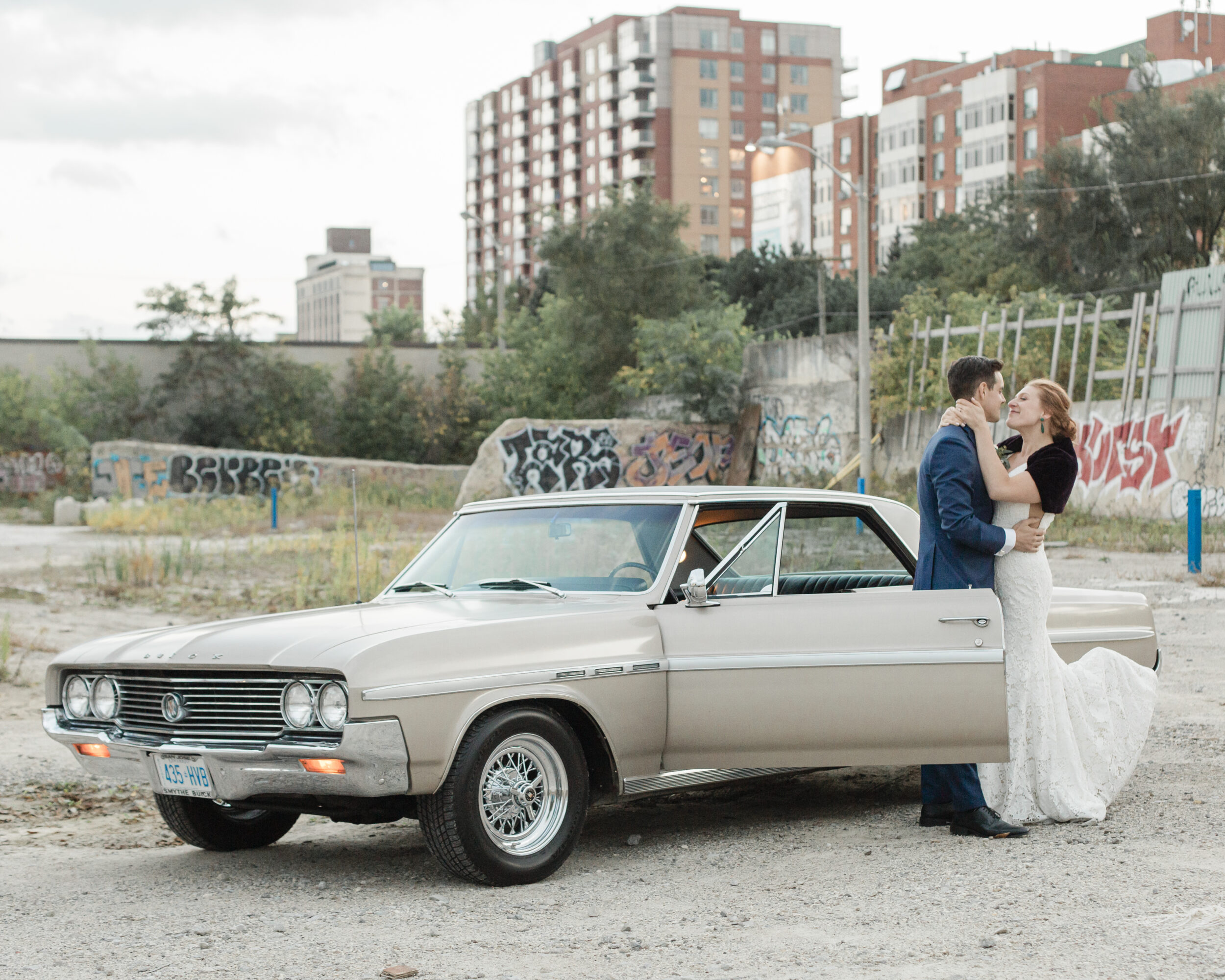 A couple embraces in an urban area during their Toronto elopement. 