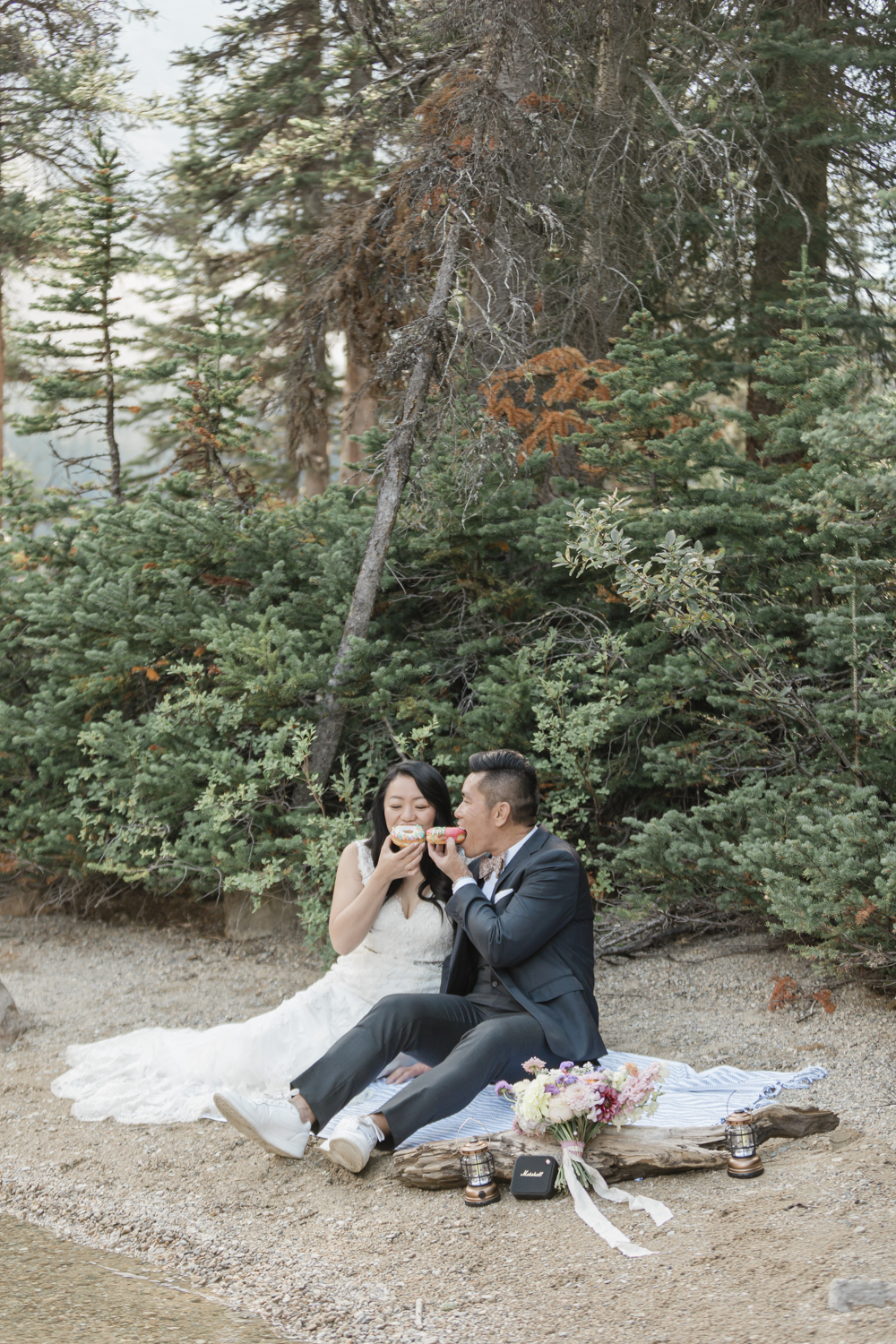 Elopement in Banff National Park eating donuts post champagne pop