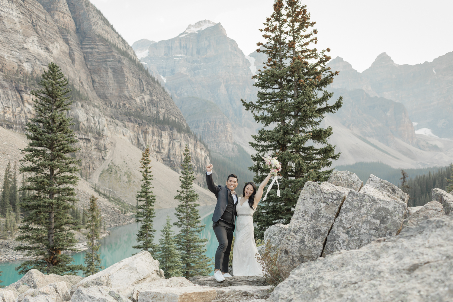 Elopement in Banff National Park couples ceremony celebrating with hands up