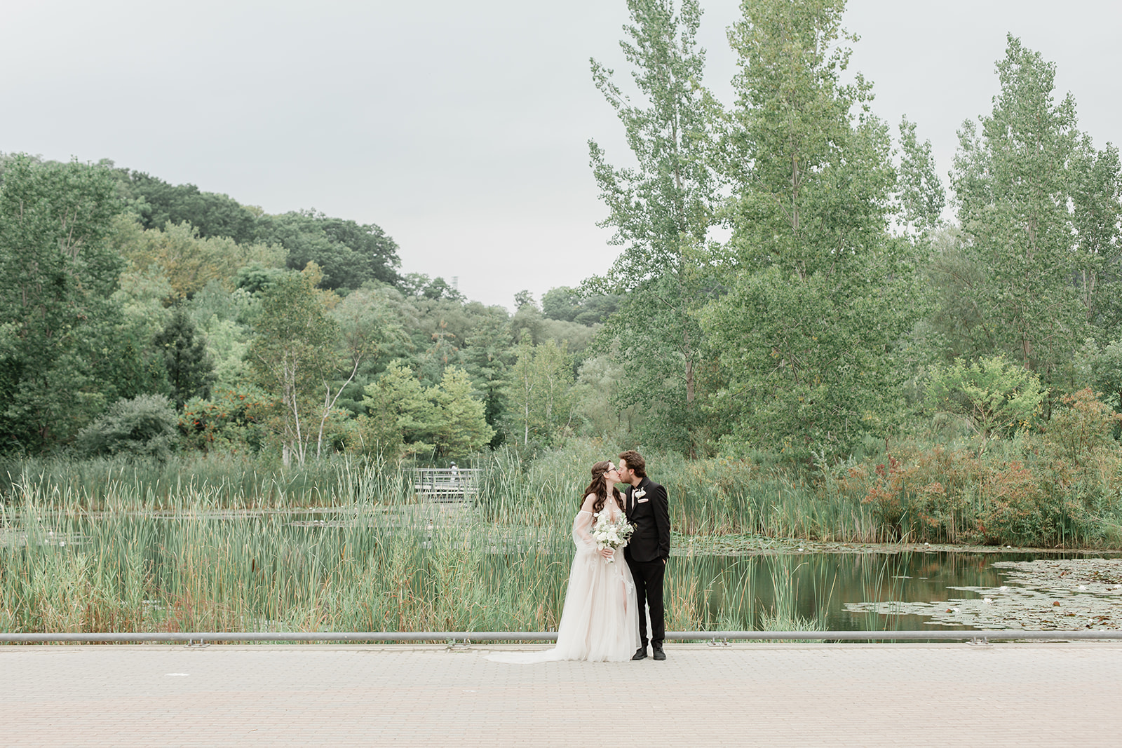 A couple kissing during their portrait session after their Toronto wedding ceremony at Evergreen Brick Works
