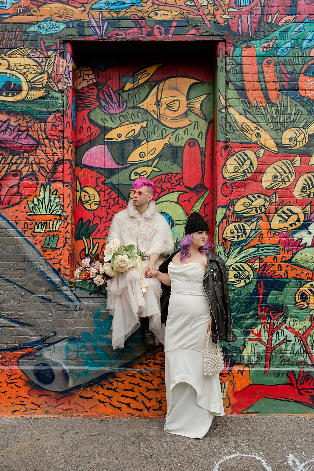 A Toronto couple getting their wedding portraits taken in Graffiti Alley 