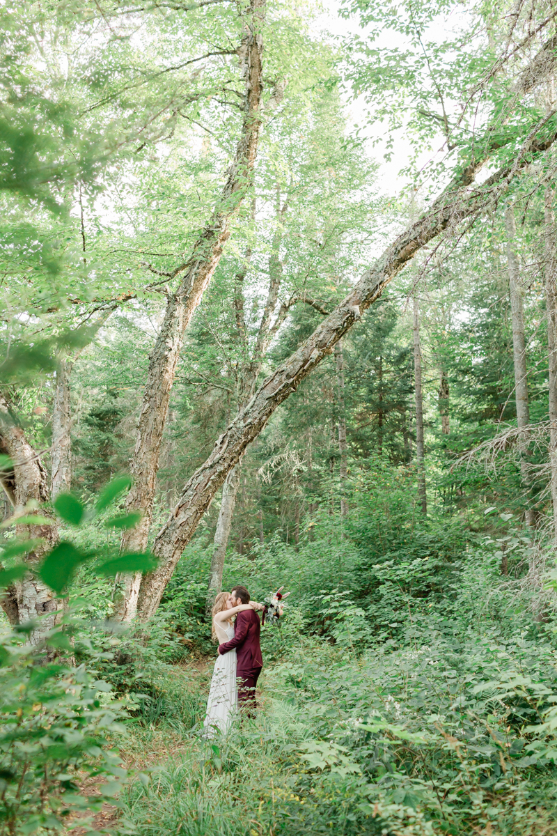 Walking along the trail hand in hand towards their ceremony spot near the waterfalls along the high falls trail in Algonquin's southgate for their Ontario elopement 