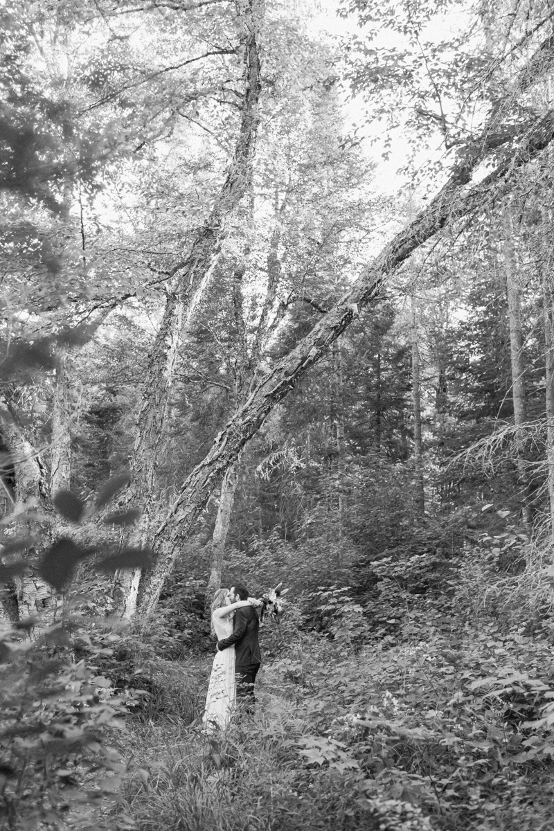 Walking along the trail hand in hand towards their ceremony spot near the waterfalls along the high falls trail in Algonquin's southgate for their Ontario elopement 