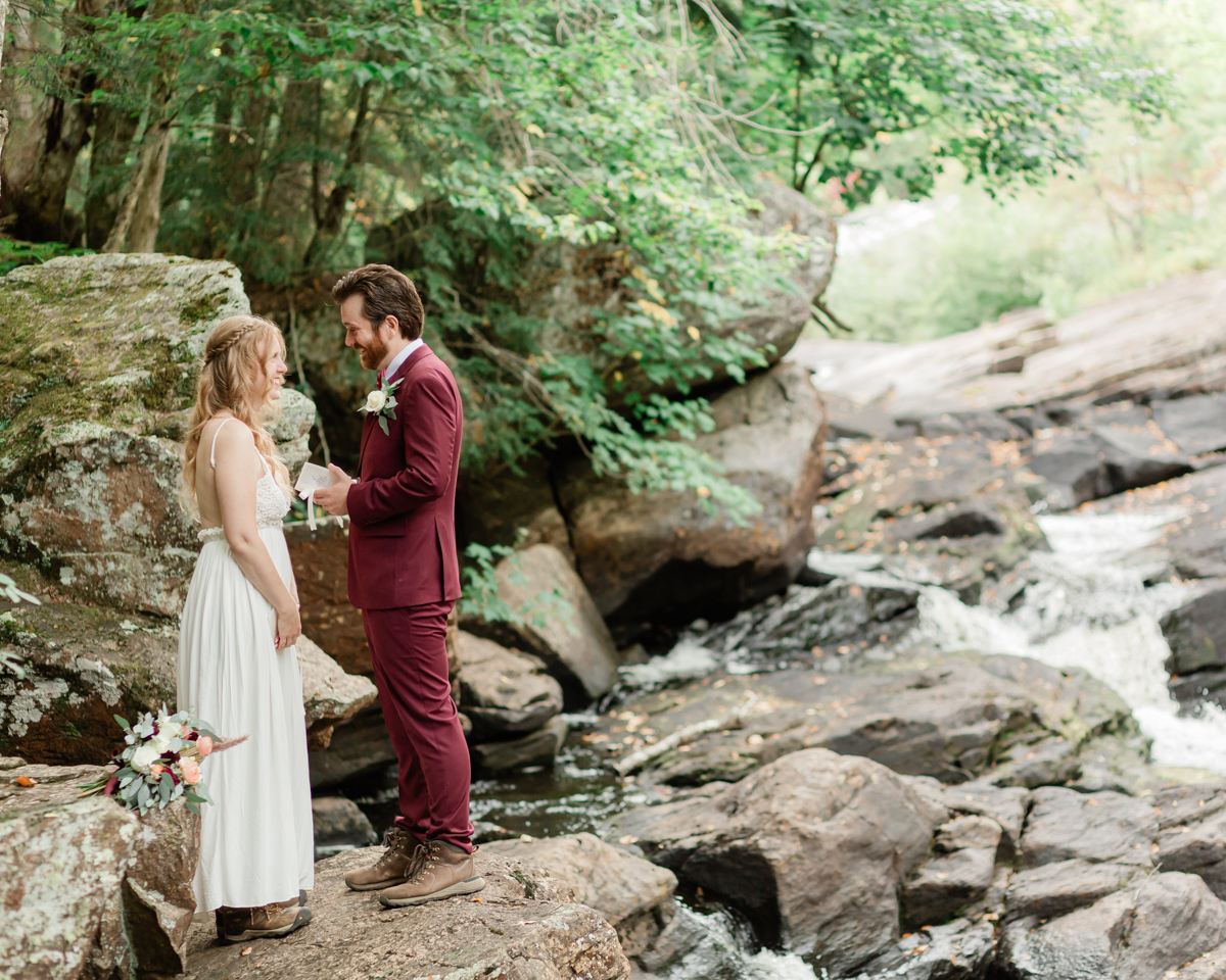 Chelsea and Kevin exchange rings and vows at High Falls for their Algonquin Park elopement in Ontario near Harcourt 