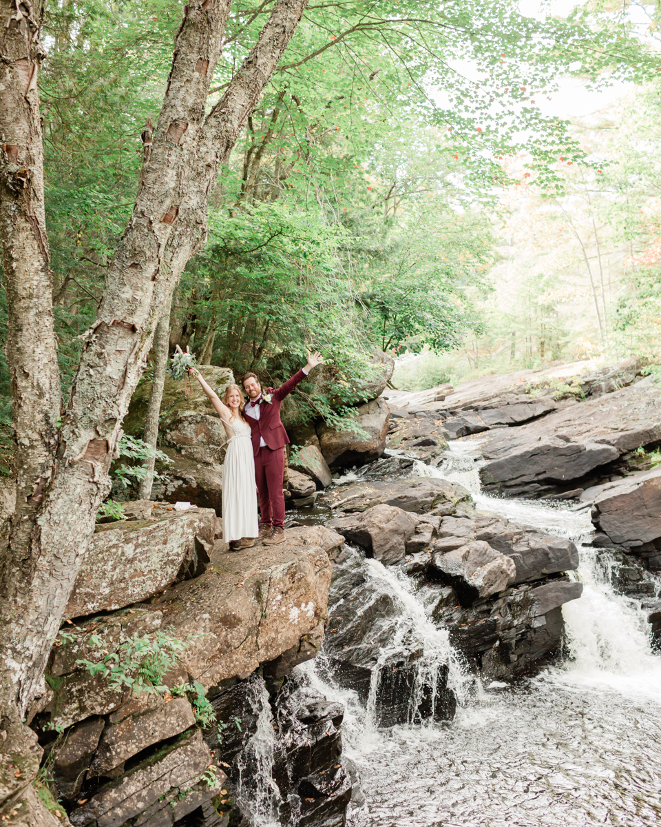 Chelsea and Kevin exchange rings and vows at High Falls for their Algonquin Park elopement in Ontario near Harcourt 