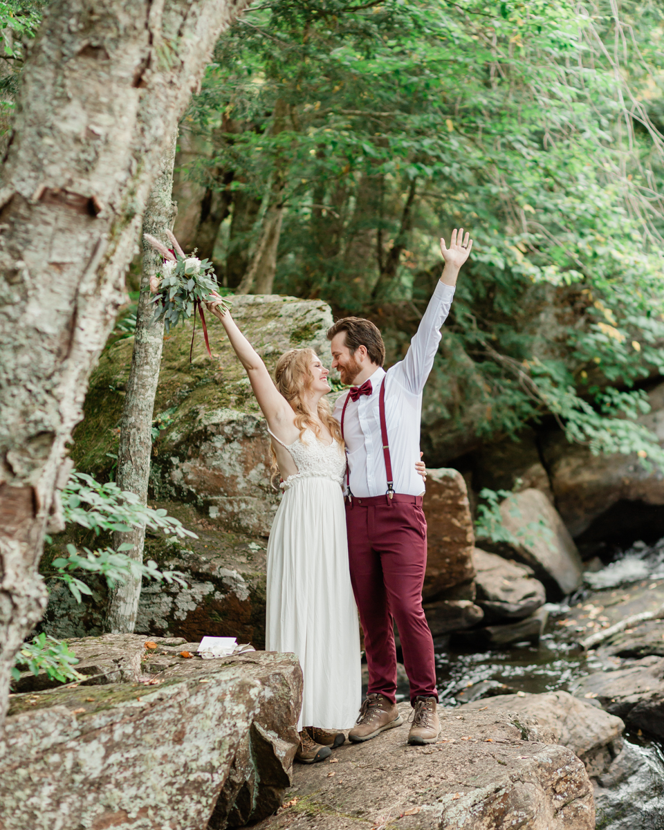 Chelsea and Kevin exchange rings and vows at High Falls for their Algonquin Park elopement in Ontario near Harcourt 