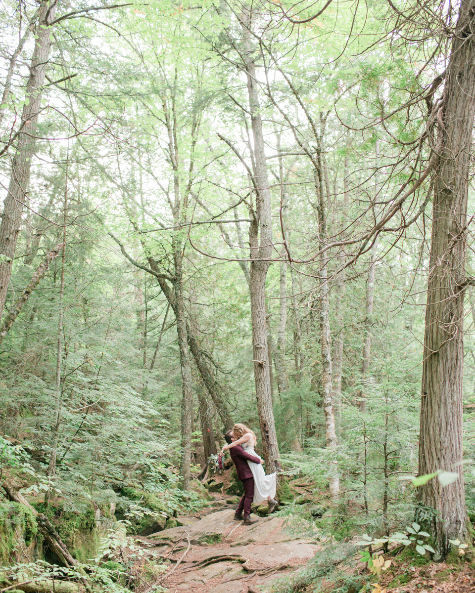 Kissing on the High Falls trail for Chelsea and Kevin's Algonquin Park elopement 