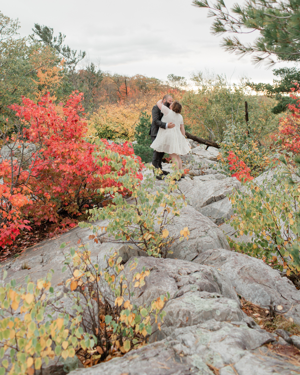 A couple kissing while hiking on Manitoulin island during their wedding 