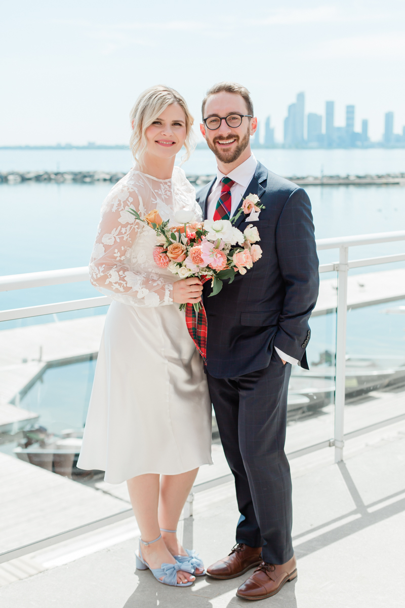 Caileigh & Garret's wedding portraits on Lake Ontario at the Henley Room with the Toronto cityscape behind them