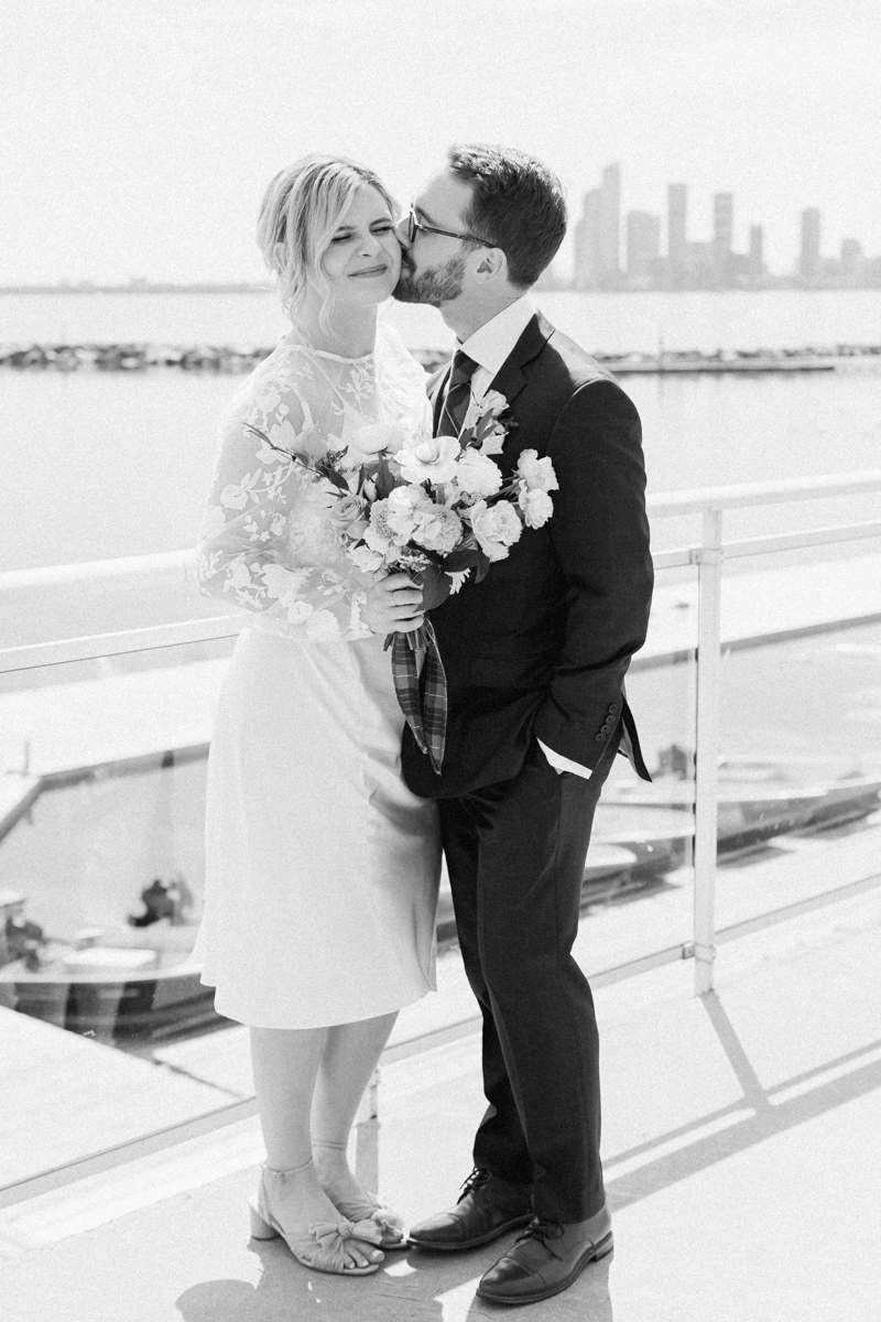 Caileigh & Garret's wedding portraits on Lake Ontario at the Henley Room with the Toronto cityscape behind them