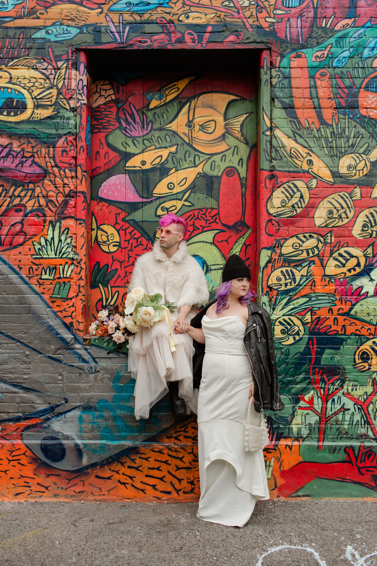 A cool couple getting married at graffiti alley on queen street west
