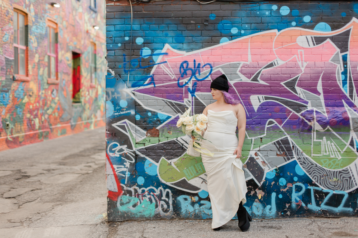 June and Trevor look cool while taking wedding portraits in graffiti alley 