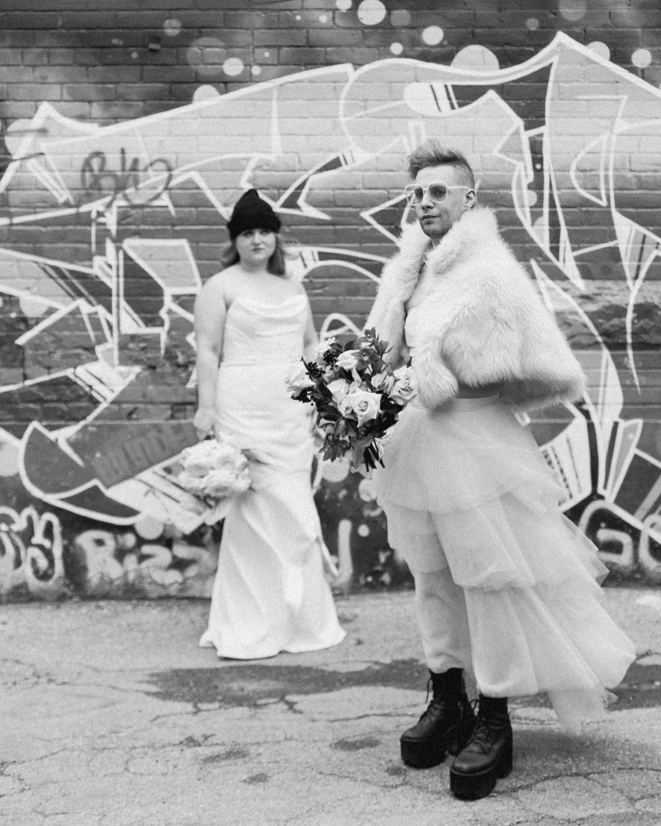 June and Trevor look cool while taking wedding portraits in graffiti alley 