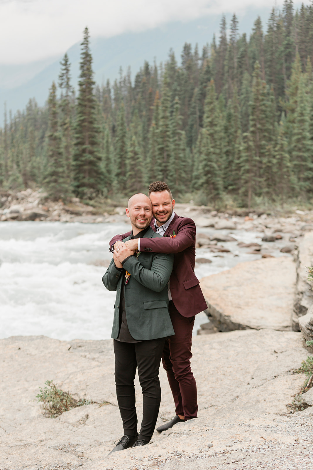 A Banff elopement couple embraces at Mistaya Canyon.