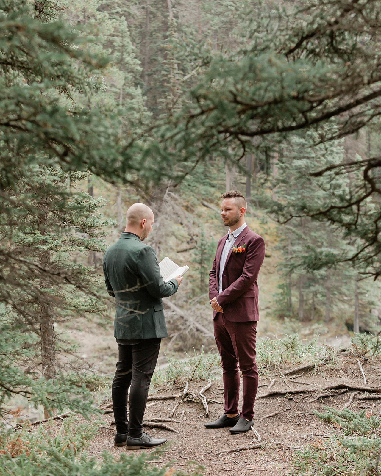 A Mistaya Canyon elopement couple reads vows to one another during an intimate outdoor ceremony. 