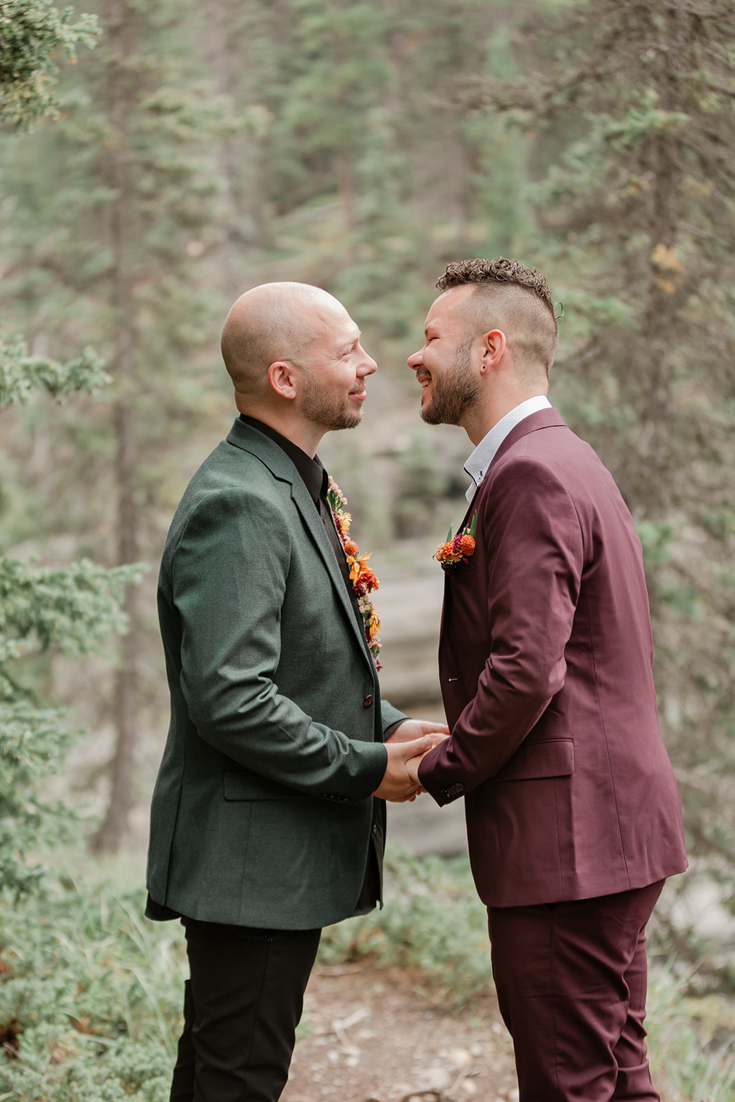 An elopement couple holds hands during an intimate Mistaya Canyon vow ceremony. 