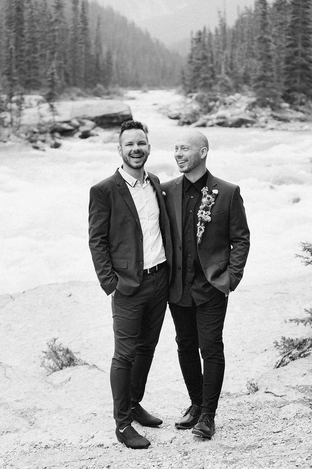 A Mistaya Canyon elopement couple embraces while smiling for a wedding portrait. 