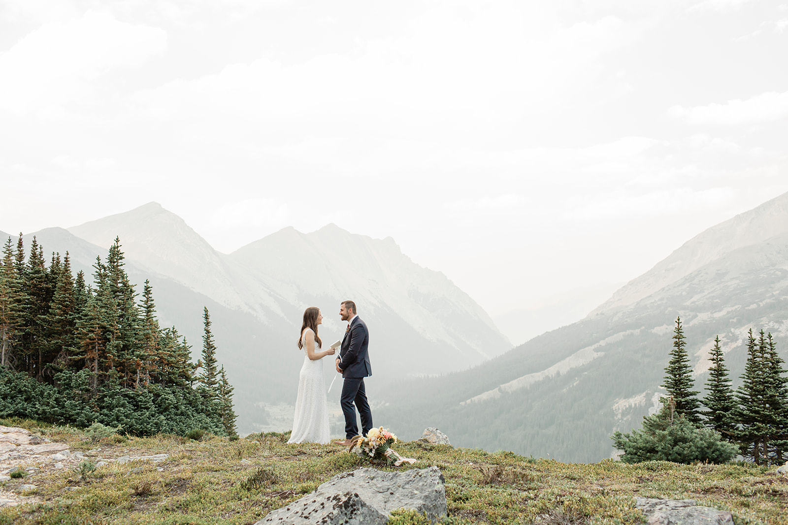 A bride recites vows to her groom during their Banff helicopter elopement ceremony. 