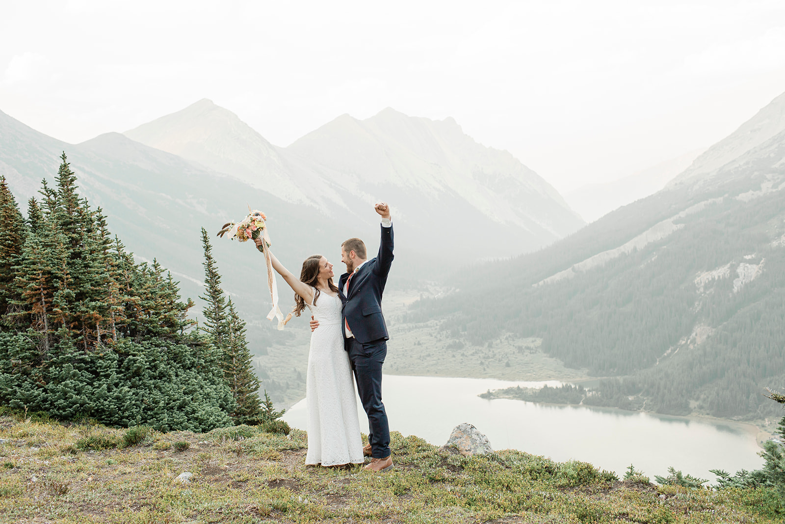 A couple cheers and celebrates their Banff elopement.