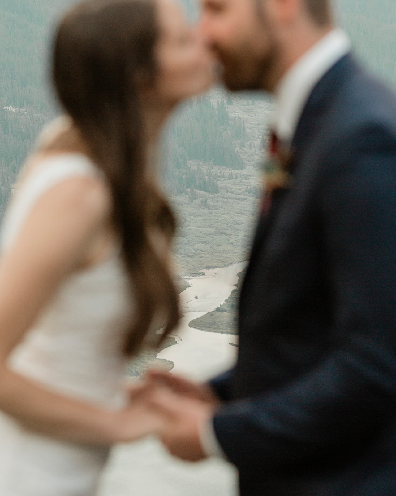 A sustainable wedding couple in Banff share a kiss during their vow ceremony. 