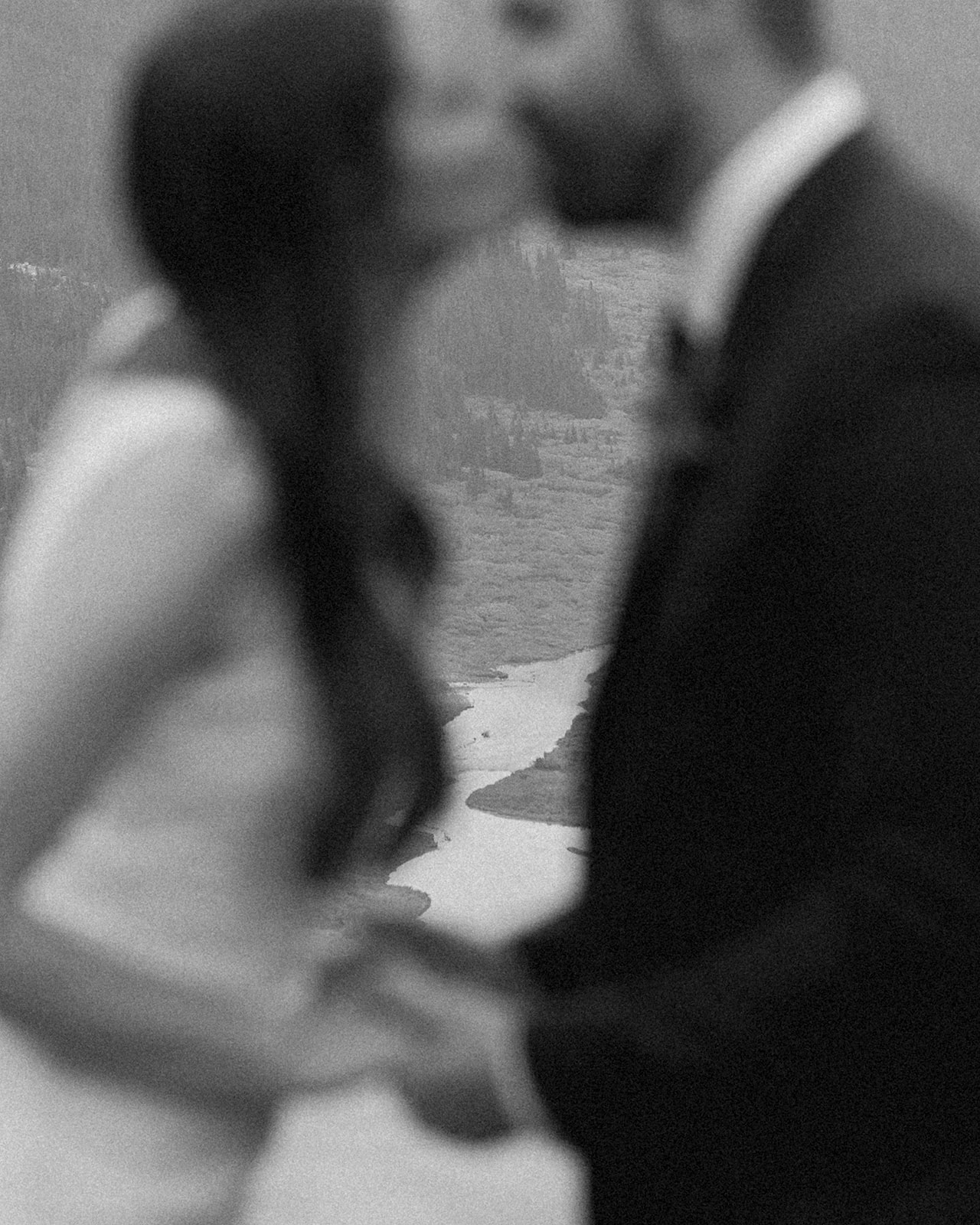 A sustainable wedding couple in Banff share a kiss during their intimate vow ceremony. 