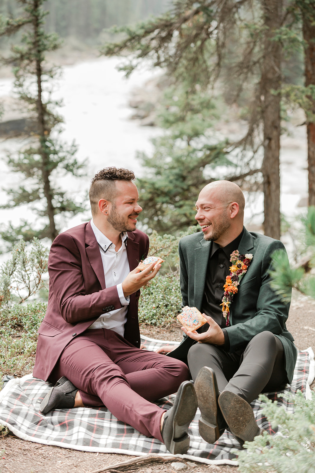 A Mistaya Canyon elopement couple shares pastries while having a picnic. 