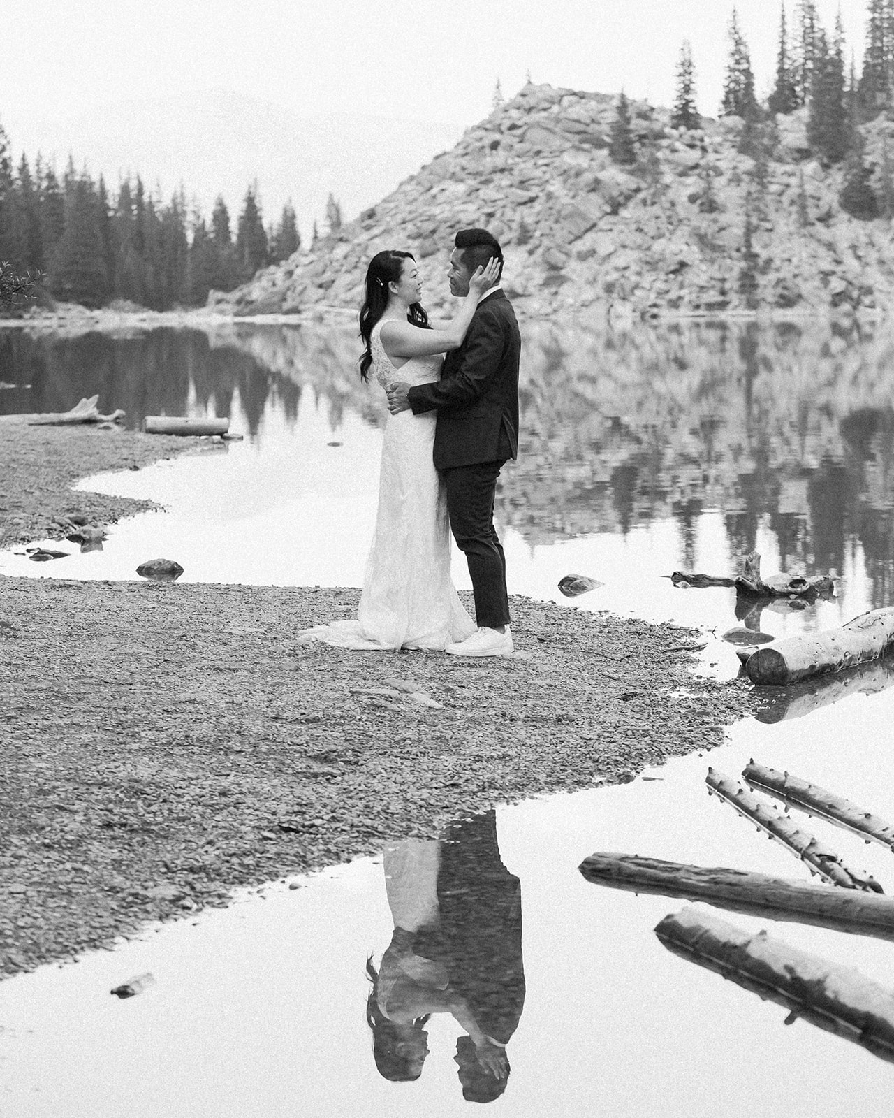 A bride holds her groom near an alpine lake in Banff National Park. 