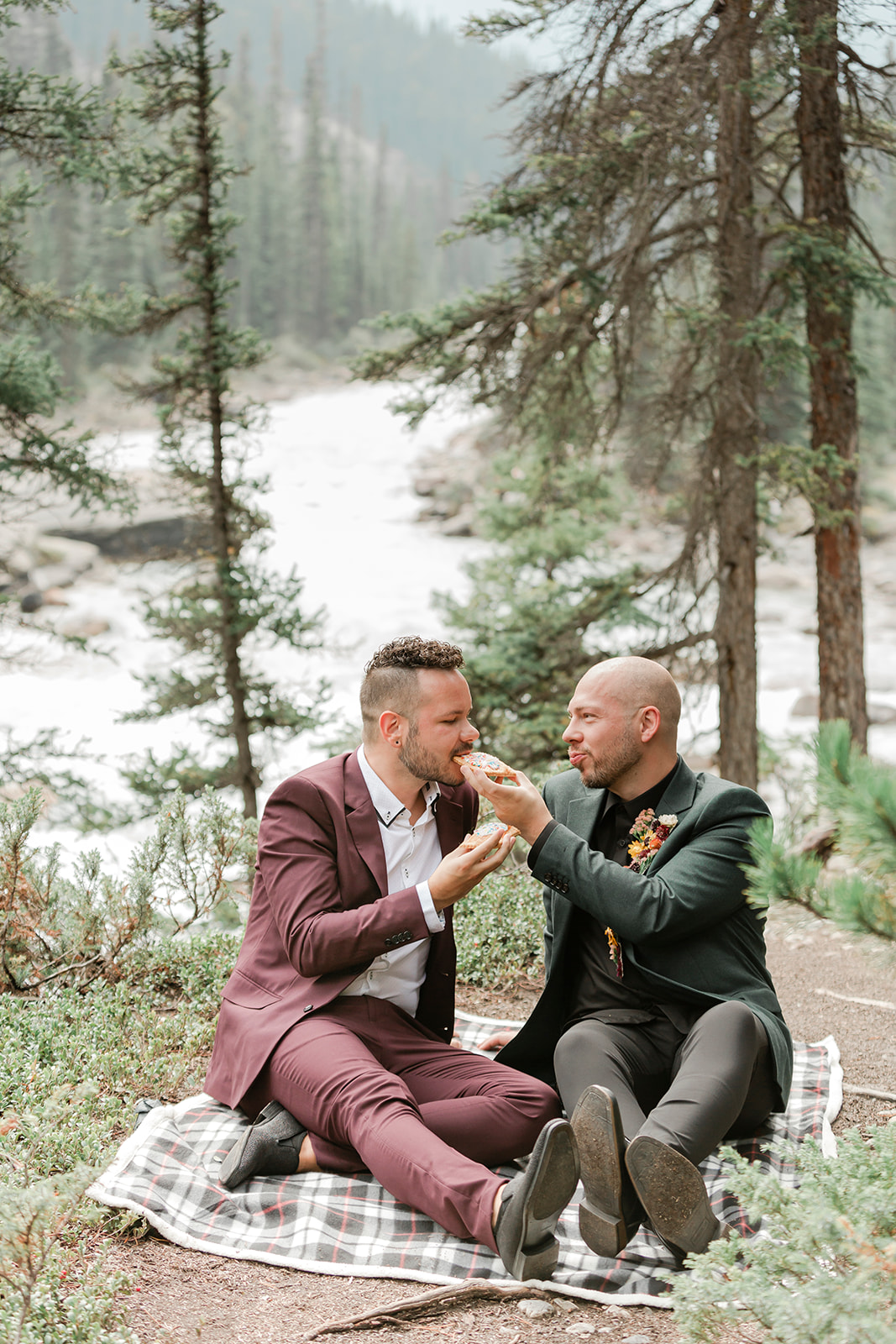 A Mistaya Canyon elopement couple shares pastries while having a picnic. 