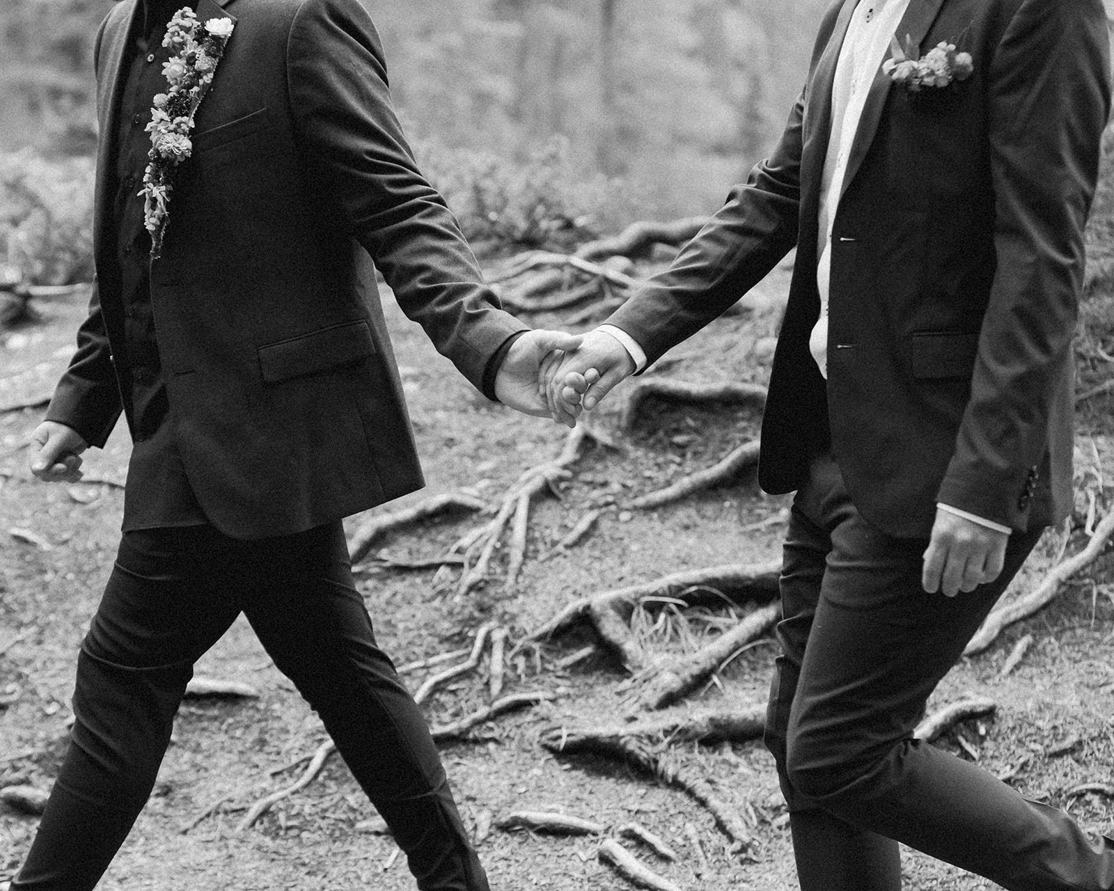 An elopement couple holds hands while walking near Mistaya Canyon. 