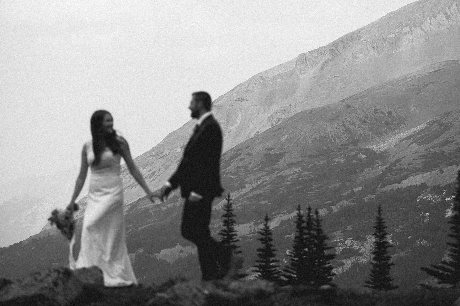 A couple walks along a ridge in Banff National Park during their hiking elopement. 