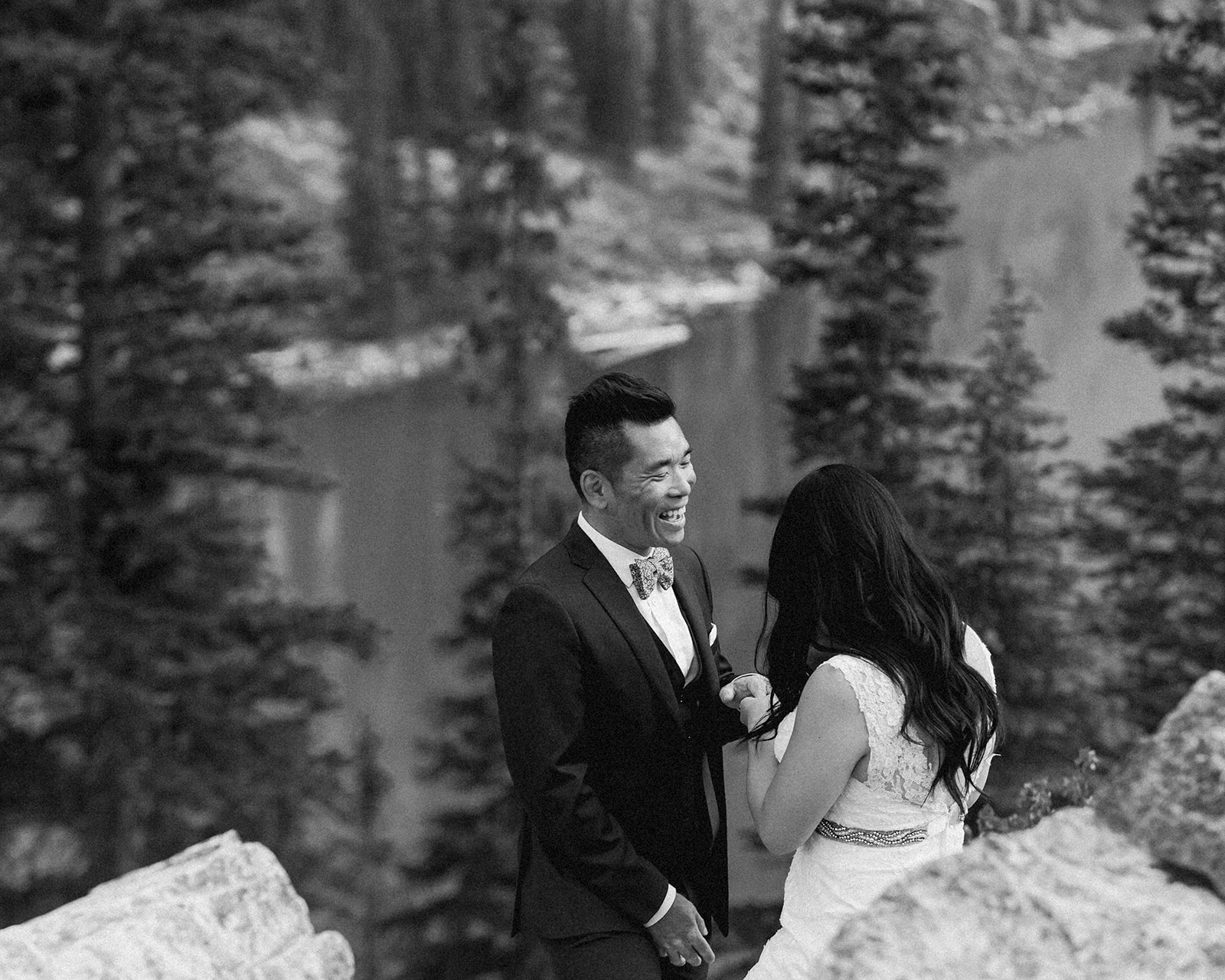 A groom smiles at his bride during their vow ceremony in Banff National Park. 