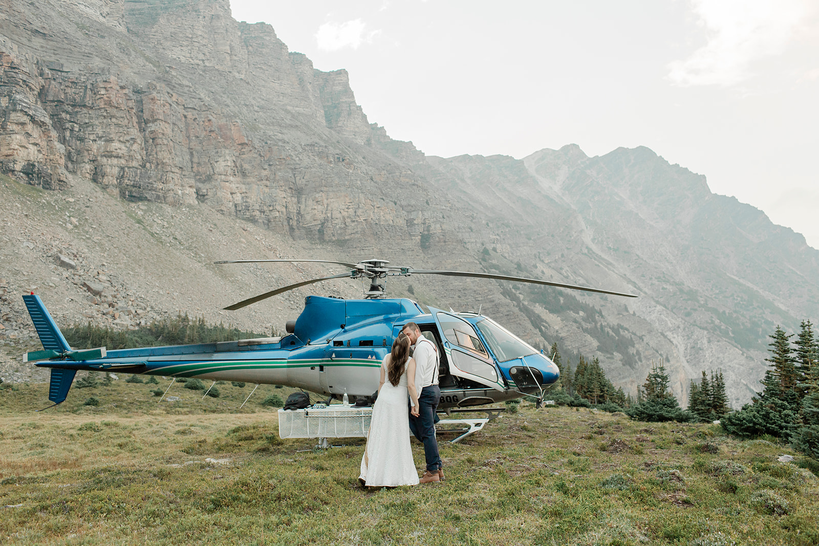 A helicopter elopement couple kisses during their Banff ceremony in Alberta. 