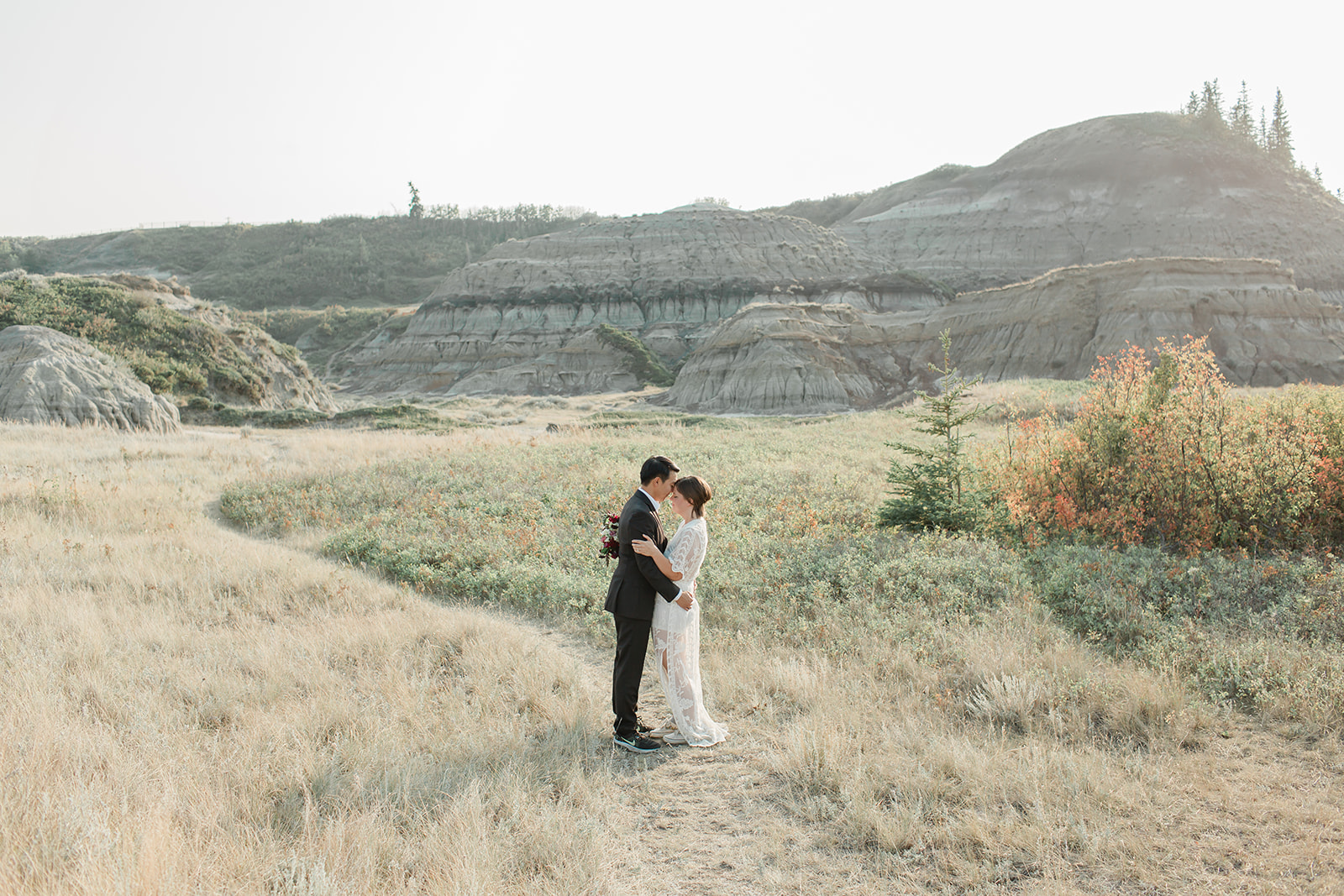 An Alberta elopement couple embraces in Horsethief Canyon during wedding portraits. 