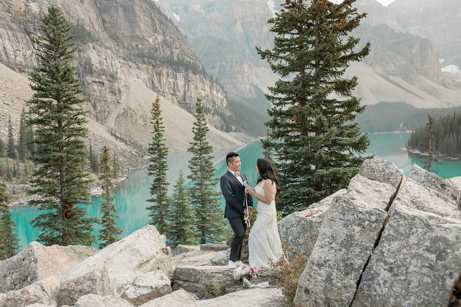 A couple recites vows during an intimate ceremony in Banff National Park during their elopement. 